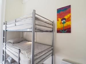 a bunk bed in a room with a painting at The Hostel in Edinburgh