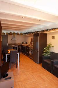 a kitchen and dining room with a table and a refrigerator at Casa Rural Caseta de l' Hort in Villafranca del Cid