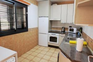 a kitchen with white appliances and a counter top at Chalet Costa Adeje in Adeje