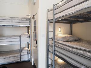 a room with three bunk beds in a room at The Hostel in Edinburgh