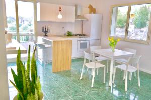 a kitchen and dining room with a table and chairs at Villa Alba in Acitrezza