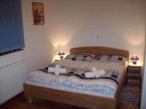 a bedroom with a bed with two lamps on it at House Mara in Korenica