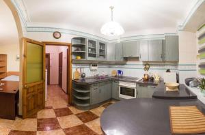 a kitchen with green cabinets and a table in it at Kyiv apartment on Pavlovskaya street in Kyiv