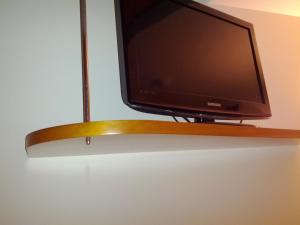 a flat screen tv sitting on top of a shelf at Doade in Hio