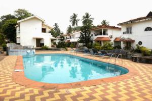 a swimming pool in the middle of a resort at CANDOLIM BEACH VILLA # 3BHK # POOL # KITCHEN # 300Mts to Beach by GR stays in Candolim