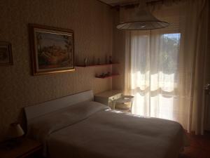 コマッキオにあるB&B Dai Nonniのベッドルーム(白いベッド1台、窓付)