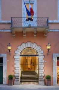an entrance to a building with stairs and a balcony at Locanda della Posta Boutique Hotel in Perugia