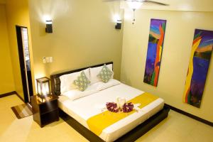 A bed or beds in a room at Sulu Sea Boutique Hotel