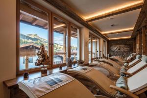 a row of chairs in a room with a mountain view at Hotel Alte Post in Fieberbrunn