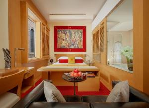 
a living room filled with furniture and a large window at Bio Hotel Raphael - Relais & Châteaux in Rome
