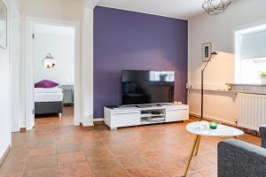 a living room with a tv and a couch at Casablanca Apartments in Keflavík