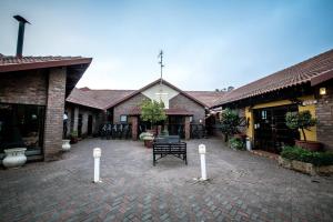 a courtyard with a bench in front of a building at First Group Qwantani in Harrismith