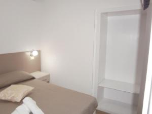 a small bedroom with a bed and a window at Appartamenti Da Nicola in Lampedusa