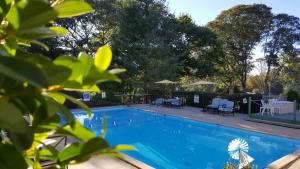 a swimming pool with a large swimming pool behind it at Starlight Lodge Cape Cod in Dennis