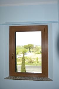 a window with a view of a street at Podere S.Giulia - casale Banditelle in Venturina Terme