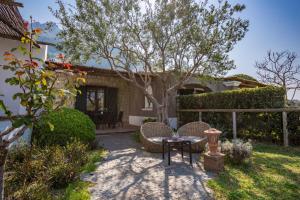 a patio with a table and chairs in front of a house at Tenuta Del Poggio Antico in Ischia