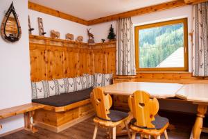 a dining room with a table and chairs at Bauernhof Entalhof in Finkenberg