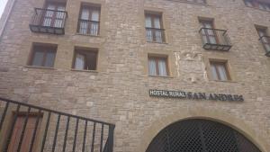 a brick building with a sign on the side of it at Hostal Rural San Andrés in Torres del Río
