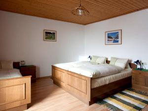 a bedroom with two beds and a wooden ceiling at Bio-Bauernhof Rettenbachgut in Werfen