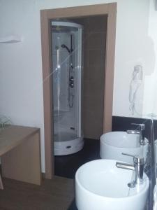 a bathroom with a shower and a toilet and a sink at Hostal Rural San Andrés in Torres del Río