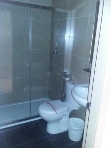 a bathroom with a shower and a toilet and a sink at Hostal Rural San Andrés in Torres del Río