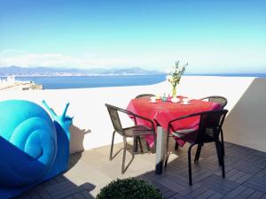 a table and chairs on a patio with a view of the ocean at Les Remparts Antibes Location in Antibes