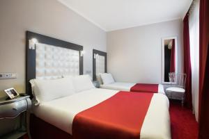 Letto o letti in una camera di Grand Hôtel Amelot