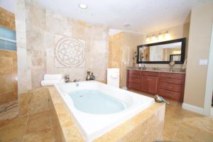 a large bathroom with a tub and a sink at Villagoona in Cape Coral +93 photos