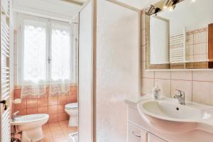 a bathroom with a sink and a toilet at Villaedi in Marina di Bibbona