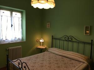 um quarto com uma cama e um candeeiro sobre uma mesa em Agriturismo Renaccio em San Lorenzo Nuovo