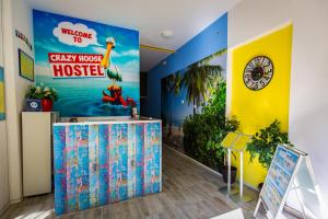 a dinosaur themed room with a welcome to crazy move house at Crazy House Hostel in Pula