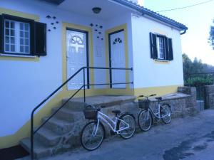 two bikes parked in front of a house at Casas DeCá & DeLá in Ponte de Lima