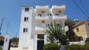 a white building with balconies on the side of it at Studio Eno Ksamil in Ksamil