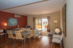 a dining room and living room with a table and chairs at Top Quality Apartment in Lagos