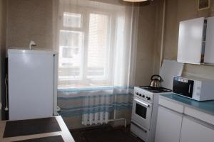 a kitchen with a white stove and a window at Apartment near Opera Hause in Dnipro