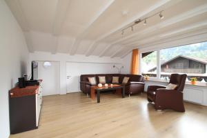 a living room with a couch and a table at Apartment Spitzenblick in Garmisch-Partenkirchen