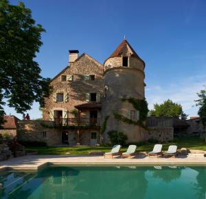 a house with a pool in front of it at Mas de Garrigue in Calvignac