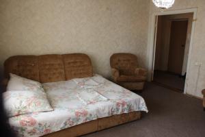 a bedroom with a bed and a chair at Apartment near Opera Hause in Dnipro