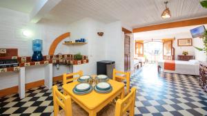 a kitchen and living room with a table and chairs at Hotel Hacienda de Vallarta Centro in Puerto Vallarta