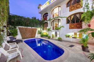 a swimming pool in the backyard of a house at Hotel Hacienda de Vallarta Centro in Puerto Vallarta