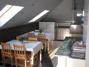 a kitchen with a dining room with tables and chairs at Pokoje Goscinne Gallick in Gdynia