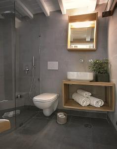 uma casa de banho com um WC, um lavatório e um espelho. em Glaros Studios em Naxos Chora mais 35 fotografias