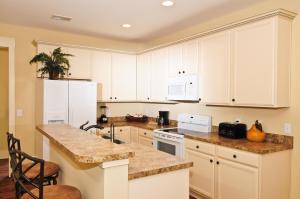 A kitchen or kitchenette at The Cottages at North Beach Resort & Villas