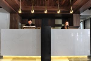 two people sitting at a desk in an office at LELUX Hotel in Montreal