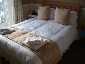 A bed or beds in a room at The Nelson Hotel 