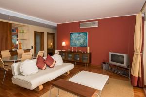 a living room with a couch and a tv at Top Quality Apartment in Lagos