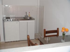A kitchen or kitchenette at Filoxenia Hotel & Apartments Még 37 kép