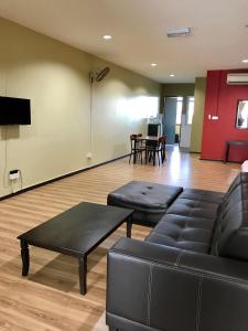 a living room with a couch and a table at SS Homestay Borneo Housing SL4 in Kampung Nombor Dua