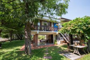a house with a balcony overlooking a lake at Phuttal Residence in Phra Nakhon Si Ayutthaya