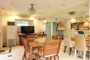 a kitchen and dining room with a table and chairs at Orchid Resort in Lat Krabang